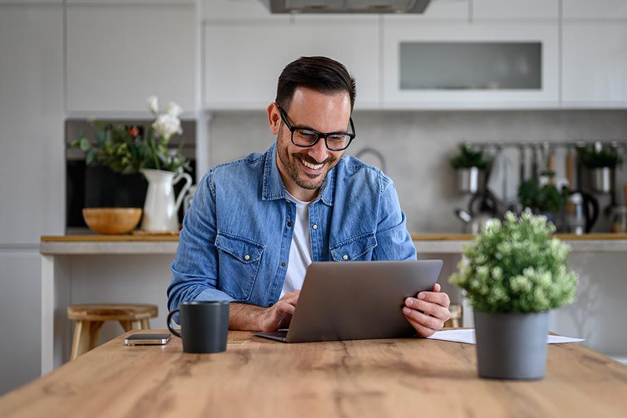 Man reviewing credit score on laptop for a better mortgage rate
