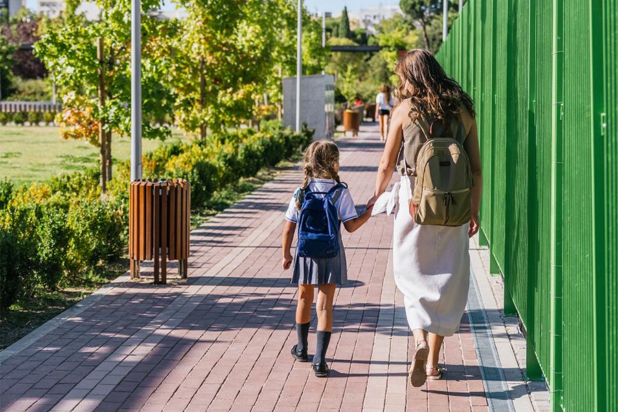 Mother and daughter up early morning in Bozeman walking to school as part of morning routines.